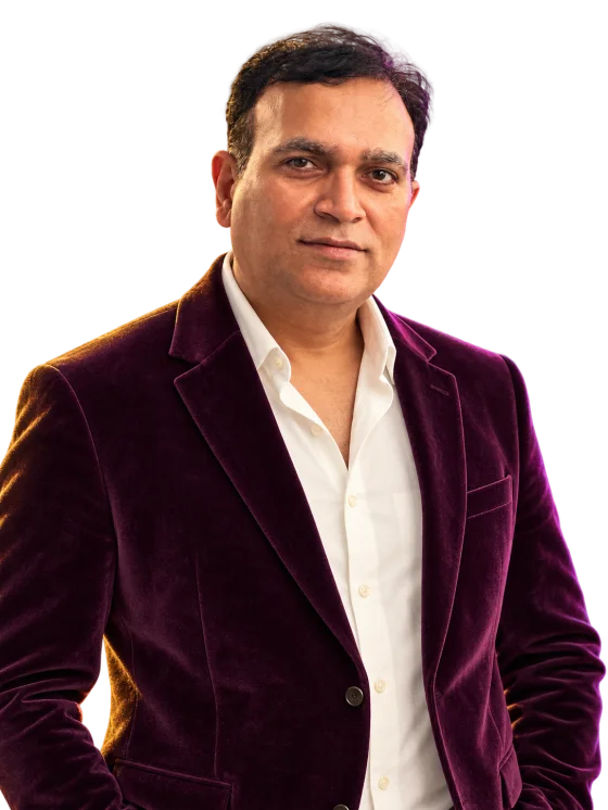 Nirbhay Singh smiling in an evening blazer, without a birthday cap